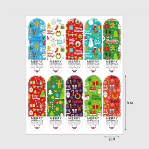 Detail view of ten colorful Christmas 7x2cm stickers featuring snowmen and deer designs