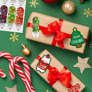Detailed view of festive Christmas stickers on kraft gift boxes with ribbons and decor