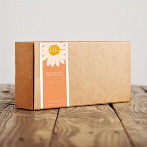 Minimalist orange rectangle seal stickers with daisy print on corrugated gift box