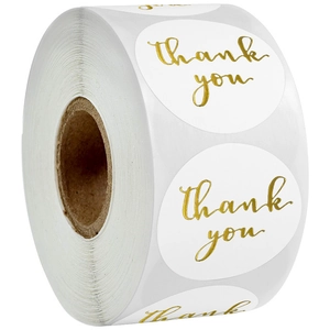 Detail of round white self-adhesive labels with gold foil thank you text on a roll