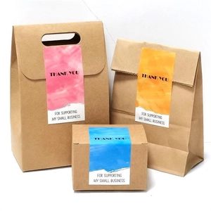 Three gradient thank you stickers on kraft paper bags and boxes for small businesses