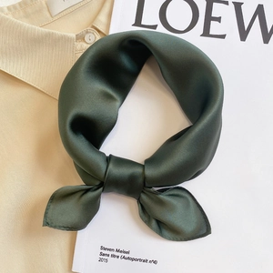 Close-up of silk neckerchief in dark green satin fabric showing smooth texture