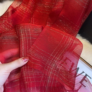 Close-up of lightweight red silk blend scarf with metallic gold thread checkered pattern