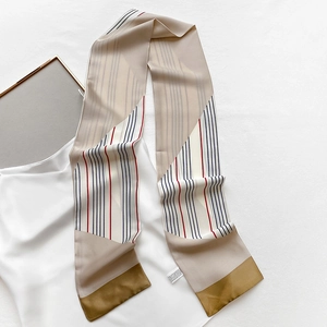 Detailed view of the silk texture and geometric patterns on this long neck scarf