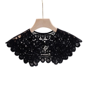 Elegant black hollow floral lace shawl with pearl button on a wooden hanger