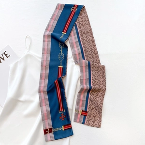 Macro view of silky narrow scarf with equestrian chain print and elegant blue beige colors