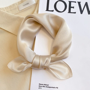 Detail of champagne silk scarf with pearl luster finish and fine stitched edges