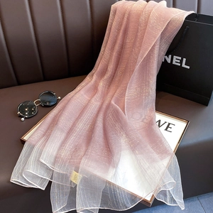 Detailed texture of pink silk blend scarf featuring subtle gold metallic threads