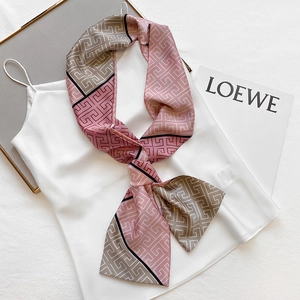 Pink and grey geometric pattern narrow silk scarf styled on a white satin camisole