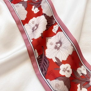 Detail von rotem Satin-Schal mit weißem Blumenmuster und rosa Kontrast-Rändern