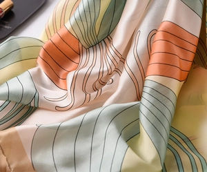 Detail of silk scarf with abstract geometric patterns and soft satin texture draping