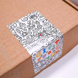 Close-up of black and white graffiti stickers sealing a brown kraft paper gift box