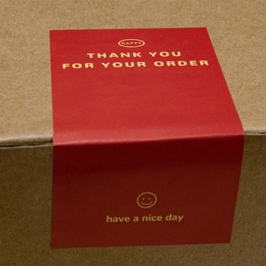 Red rectangular Thank You For Your Order stickers on kraft box for packaging seal