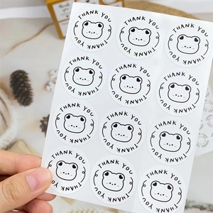 Close-up of cute cartoon frog thank you stickers for packaging seals and gift boxes