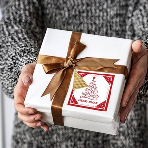Christmas gold triangle metal pendant hanging on gift box with Merry Xmas card