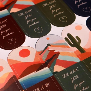Macro view of boho style adhesive thank you stickers for gift packaging seals