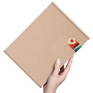 Brown kraft cardboard shipping box with decorative mountain and sun art sticker