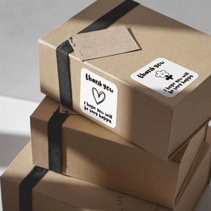 Square Thank You stickers on kraft gift box with black ribbon and hand-drawn patterns