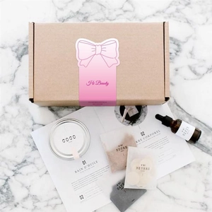 Pink bow sticker with Hi Beauty text on a brown kraft gift box for skincare packaging