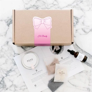 Pink minimalist aesthetic beauty gift box set with skin care products on marble background