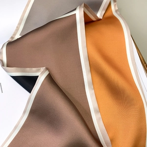 Detailed view of luxury geometric color-block satin scarf texture and elegant drape