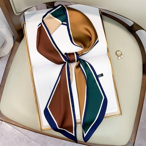 Close-up of retro polka dot silk scarf tied on a white chair with pearl ring detail