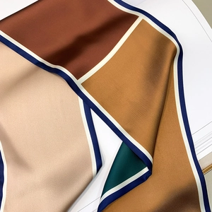 Detailed view of polka dot pattern long silk scarf with smooth satin texture and elegant folds