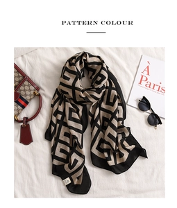 Detail view of cotton linen shawl with geometric Greek fret pattern and chic accessories