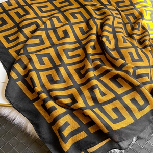 Close-up of geometric maze pattern on black and yellow cotton-linen feel scarf texture