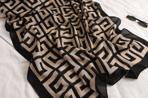 Detailed view of lightweight cotton-linen shawl with black geometric patterns and wide borders