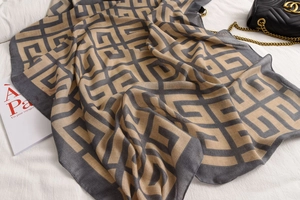 Detail of soft cotton-linen shawl featuring grey and beige geometric pattern and soft texture