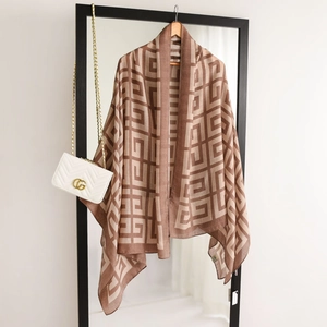 Macro detail of geometric pattern on cotton-linen scarf hanging on a wooden hanger