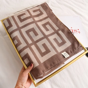 Detail of cotton linen scarf with geometric greek key pattern and tassel edges