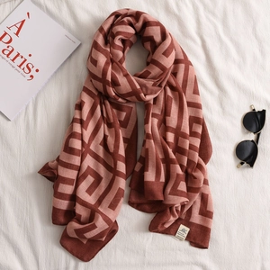 Detail view of cotton linen scarf with red and pink Greek key geometric pattern