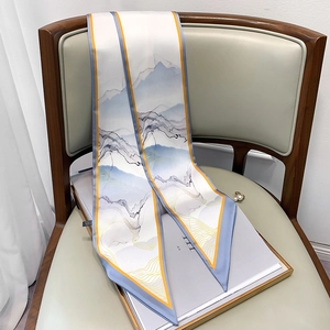Detail of artistic oil painting pattern twilly scarf draped on a leather chair