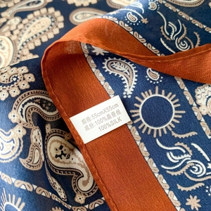 Detail of 100% mulberry silk paisley scarf with orange edges in 55x55cm size