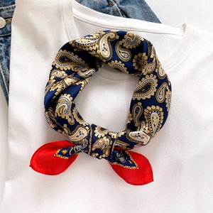 Elegant paisley silk scarf for women in navy and gold styled on a casual outfit