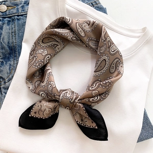 Brown paisley silk scarf styled on a white T-shirt with casual denim background