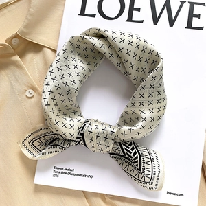 Elegant silk scarf with black geometric pattern on off-white background accessory