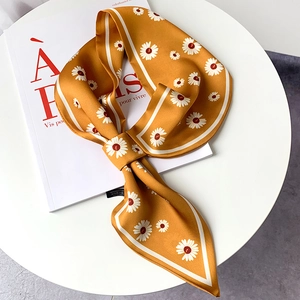 Chic mustard yellow silk scarf with white daisy floral print and elegant knotted detail