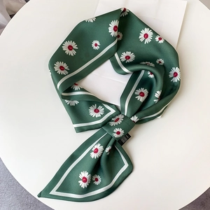 Close-up of a dark green narrow silk scarf with white daisy prints and linear borders