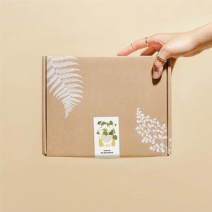 Close-up of brown gift box with white leaf patterns and a Thank You seal sticker