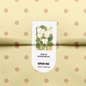 Detailed view of floral rectangular stickers on packaging for gift box sealing