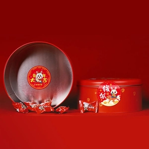 Macro detail of red tin candy jar with Rabbit Year festive motifs and New Year sweets