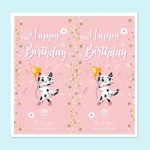 Detail of pink birthday stickers featuring cartoon cat and golden star patterns