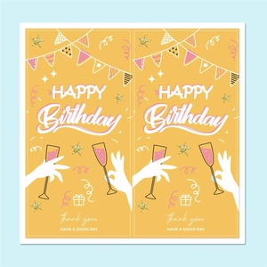 Macro detail of yellow Happy Birthday stickers with cake and champagne bottle illustrations