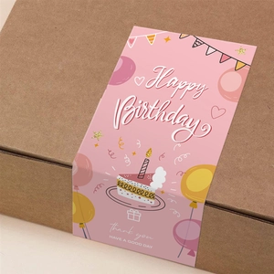 Pink Happy Birthday rectangle packaging stickers on a brown corrugated box for gift sealing