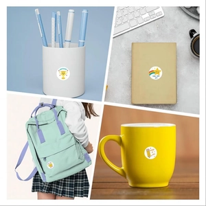 Round cartoon reward stickers applied on a pencil holder, notebook, backpack, and mug