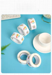 Close-up of five rolls of colorful cartoon reward stickers with encouraging phrases