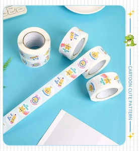 Detail of round reward stickers on rolls featuring colorful cartoon motivational designs